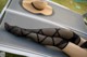 A woman laying on a lounge chair with a hat on her head.