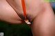 A close up of a woman's butt with an orange ribbon around her butt.