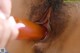 A close up of a person holding a dildo in their mouth.