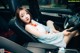 A woman sitting in the driver's seat of a car.