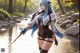 A woman with blue hair holding a sword in a river.