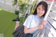 A young woman in a school uniform posing for a picture.