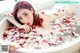 A woman laying in a bathtub filled with rose petals.