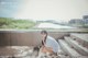 A woman sitting on the steps of an abandoned building.