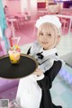 A woman holding a tray with a dessert on it.