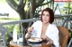 A woman sitting at a table with a plate of food.